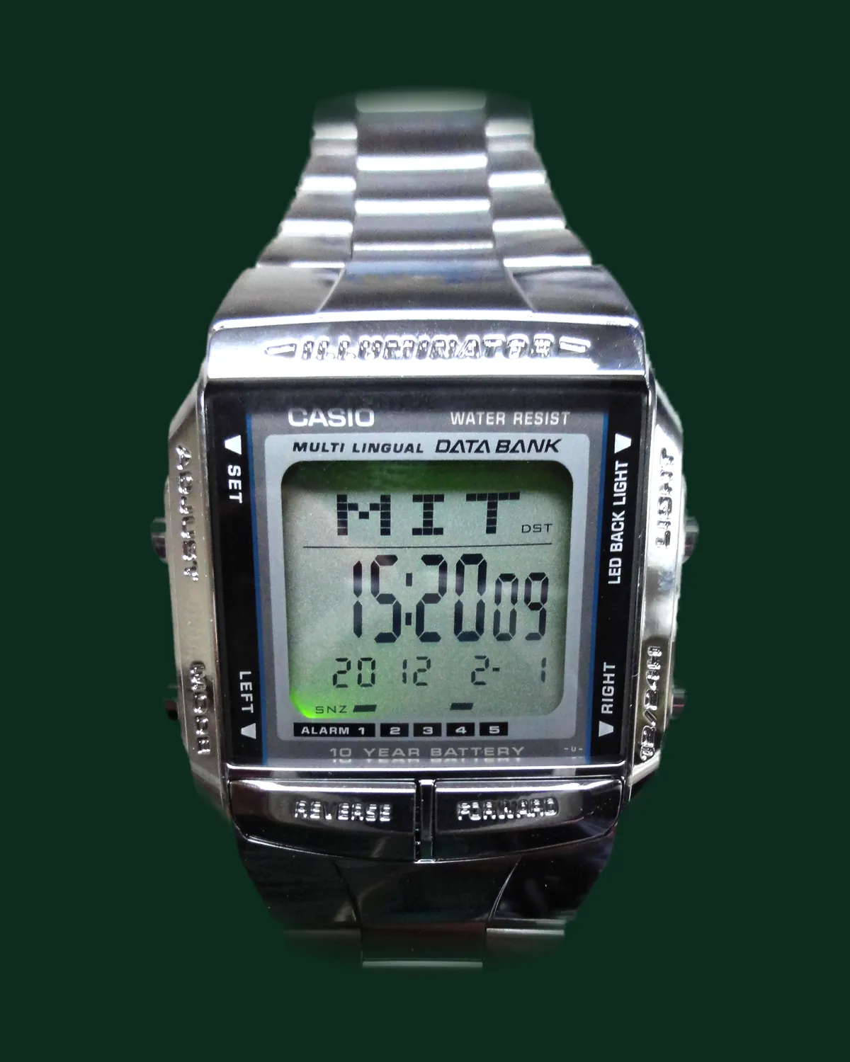 A digital watch with a steel bracelet and a busy dial