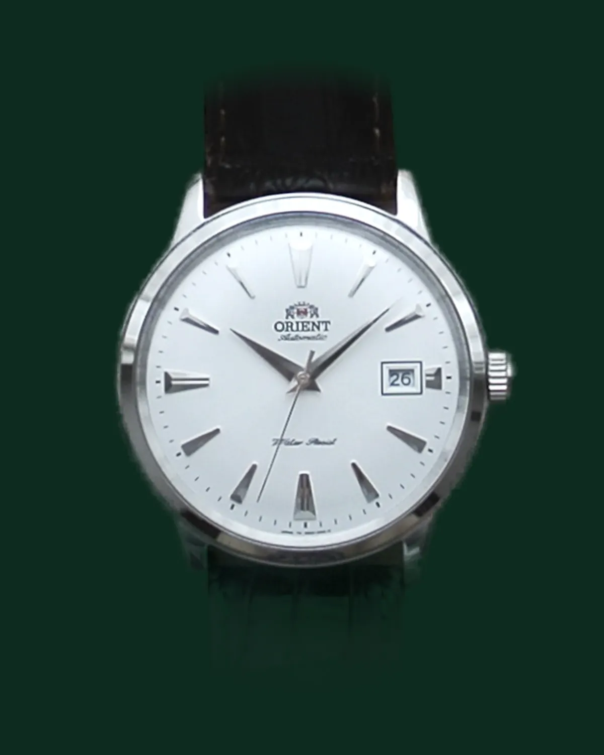 A dress watch with a white dial and a leather strap